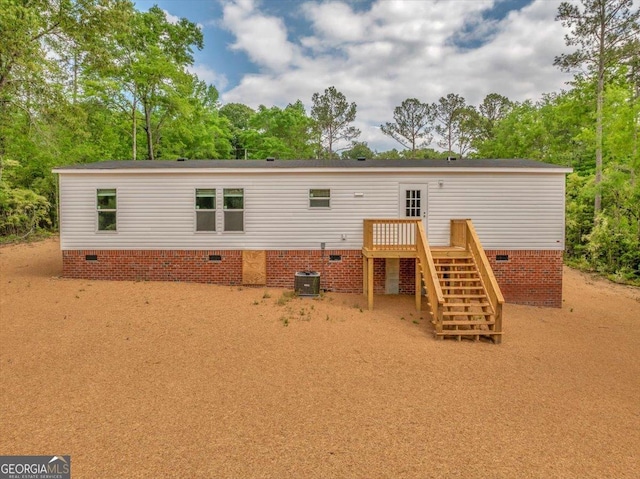 back of property with stairs, a wooden deck, central AC, and crawl space