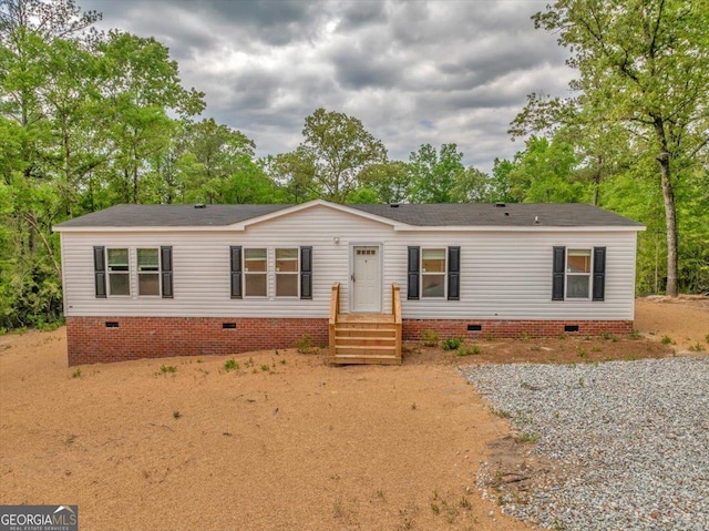 view of front of property featuring roof with shingles and crawl space