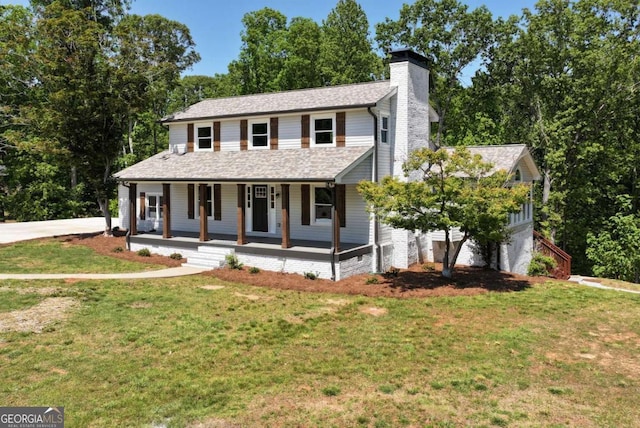 view of front of house featuring a porch, a garage, a front lawn, and a chimney
