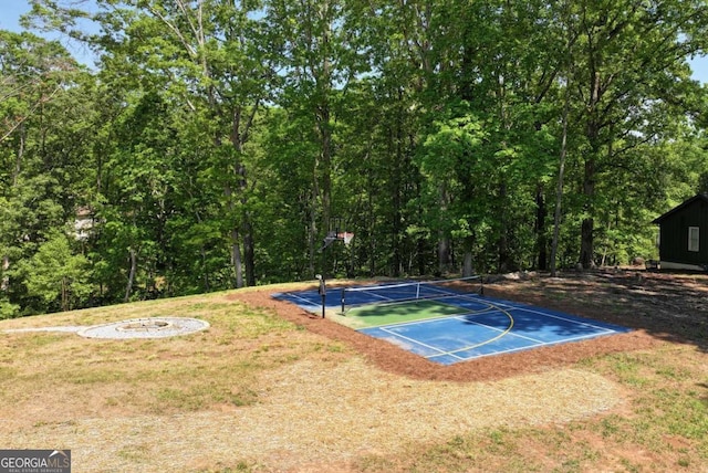 view of basketball court featuring a lawn and basketball court