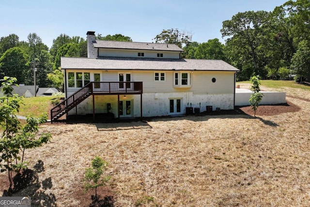 rear view of house with a deck, french doors, a chimney, central air condition unit, and stairway