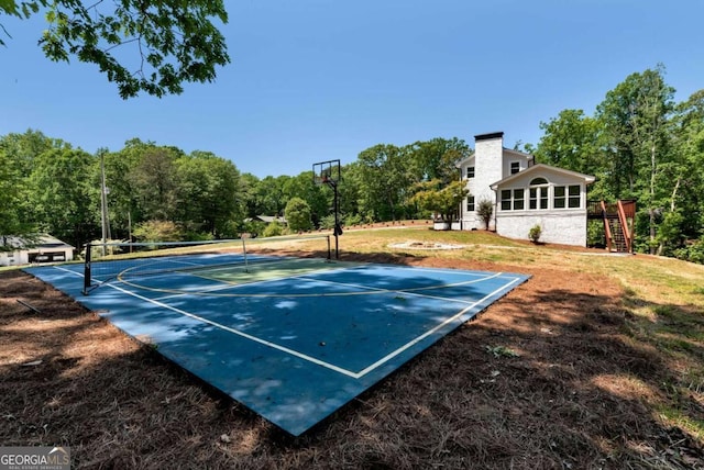view of sport court featuring basketball court, a lawn, a tennis court, and stairway