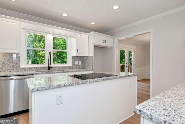 kitchen with a sink, light wood-type flooring, black electric stovetop, and dishwasher