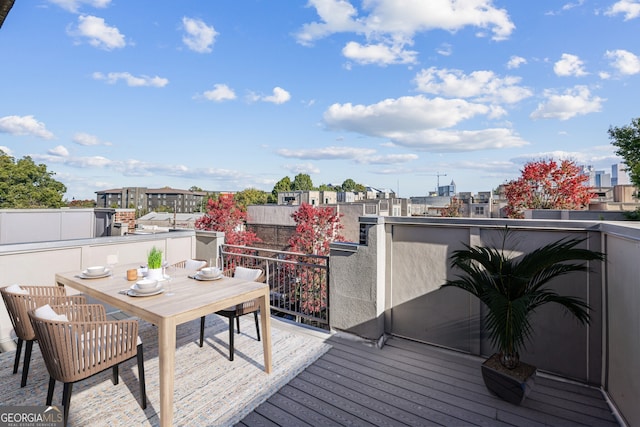 wooden terrace featuring outdoor dining space