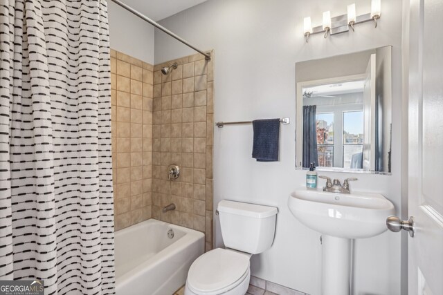 bathroom with shower / bath combo with shower curtain and toilet