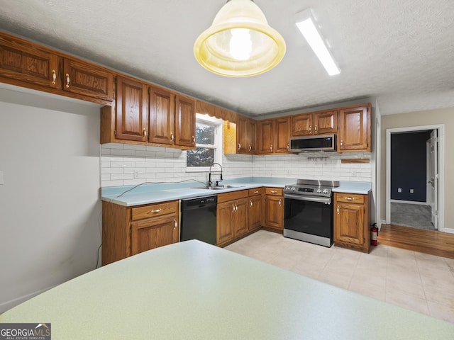 205 Crooked Pine Trl, Baldwin, GA 30511 - kitchen featuring backsplash, appliances with stainless steel finishes, brown cabinets, a sink, and light countertops