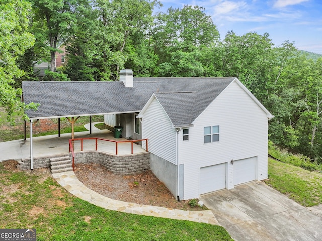205 Crooked Pine Trl, Baldwin, GA 30511 - view of front of home with a garage, roof with shingles, a chimney, and concrete driveway