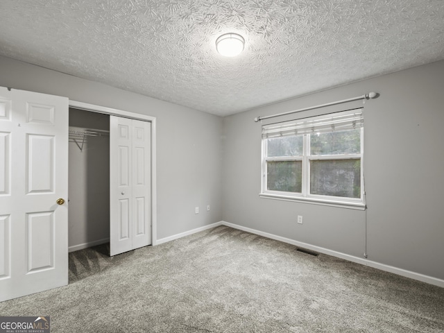 205 Crooked Pine Trl, Baldwin, GA 30511 - unfurnished bedroom with a textured ceiling, carpet, baseboards, visible vents, and a closet