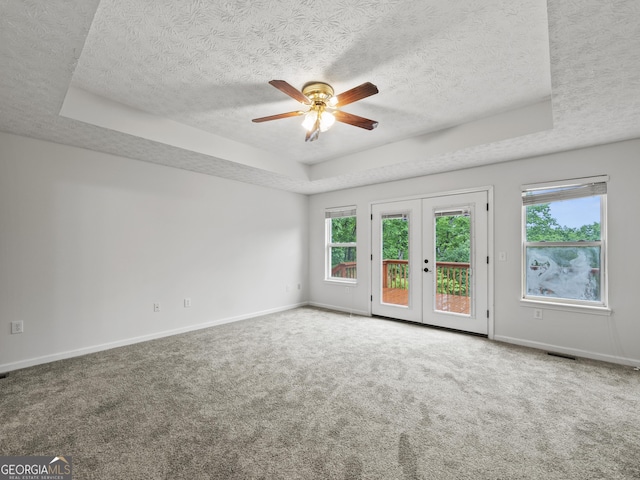 205 Crooked Pine Trl, Baldwin, GA 30511 - carpeted empty room featuring a textured ceiling, a raised ceiling, ceiling fan, and a wealth of natural light