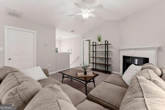 1628 Brook Ln, Monroe, GA 30655 - carpeted living room with vaulted ceiling, ceiling fan, and a glass covered fireplace