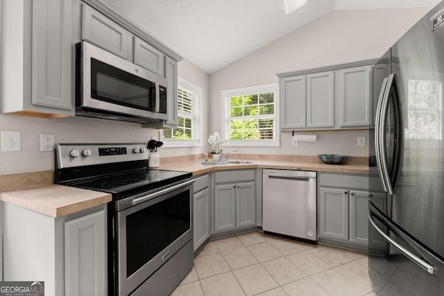 1628 Brook Ln, Monroe, GA 30655 - kitchen featuring appliances with stainless steel finishes, gray cabinets, lofted ceiling, and light countertops
