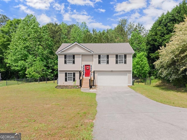 1628 Brook Ln, Monroe, GA 30655 - raised ranch with a garage, driveway, and view of wooded area