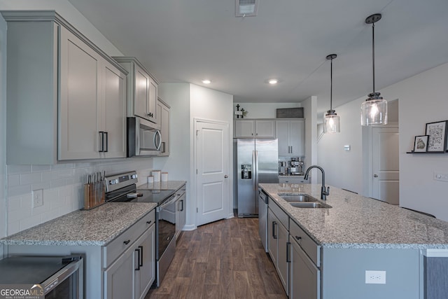 110 Cole St, Pooler, GA 31322 - kitchen with decorative backsplash, dark wood-style flooring, light stone counters, a sink, and appliances with stainless steel finishes