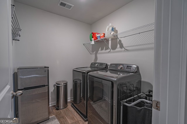 110 Cole St, Pooler, GA 31322 - clothes washing area with visible vents, laundry area, wood finished floors, and separate washer and dryer