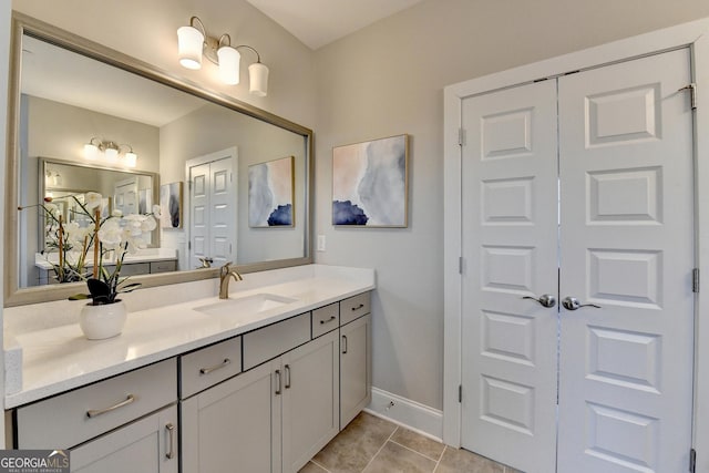 606 Broadview Ter NE, Atlanta, GA 30324 - bathroom with a closet, baseboards, tile patterned flooring, and vanity