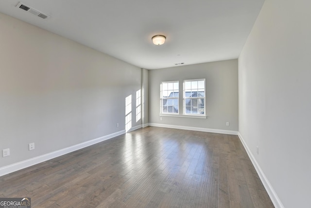606 Broadview Ter NE, Atlanta, GA 30324 - empty room with baseboards, dark wood-style flooring, and visible vents