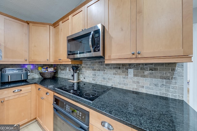 kitchen with dark stone countertops, backsplash, black appliances, and light brown cabinets