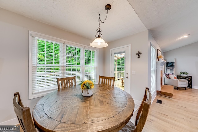 dining area featuring a healthy amount of sunlight, baseboards, and light wood-style flooring