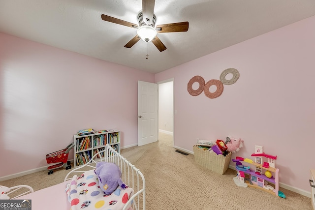 game room with carpet floors, baseboards, and a ceiling fan