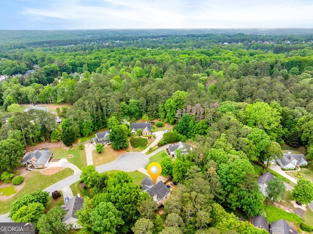 birds eye view of property with a wooded view