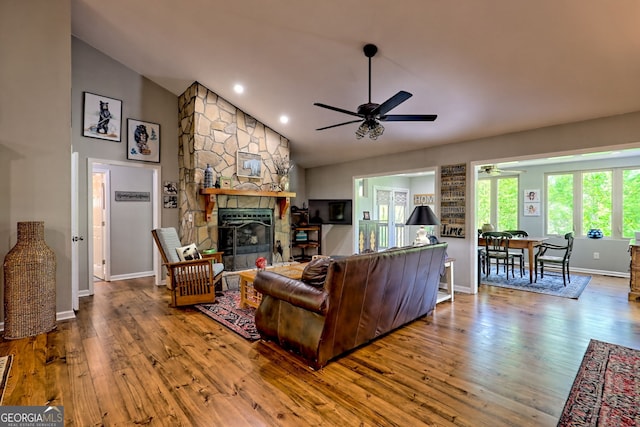 living room with ceiling fan, a fireplace, recessed lighting, baseboards, and wood finished floors