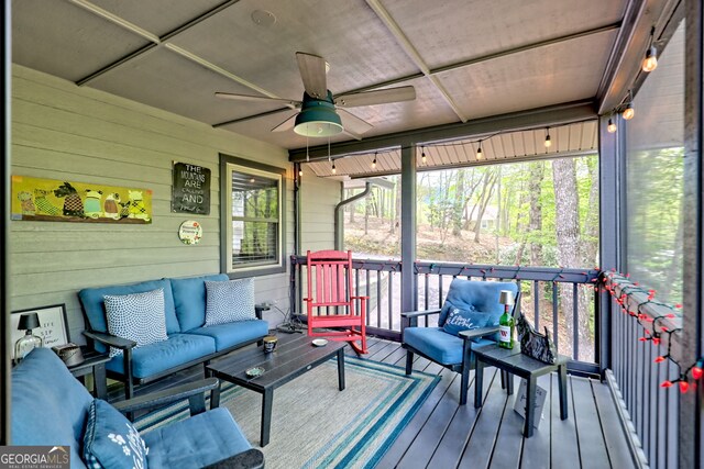 deck with an outdoor living space and a ceiling fan