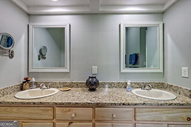 full bath featuring a sink and double vanity