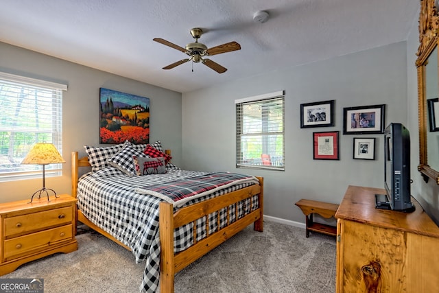 bedroom featuring a ceiling fan, baseboards, and carpet