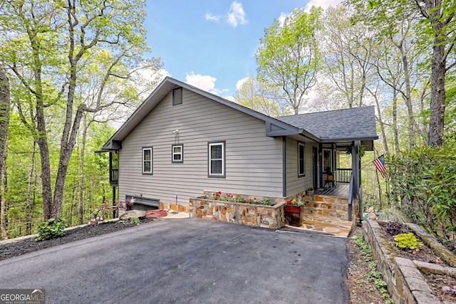 view of property exterior with a shingled roof