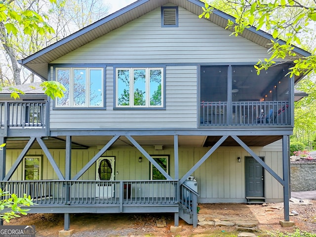 back of property featuring a deck
