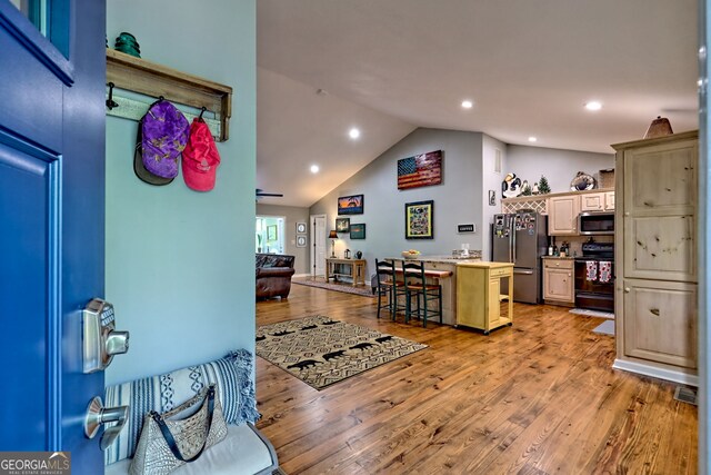 interior space featuring visible vents, recessed lighting, light wood finished floors, and high vaulted ceiling