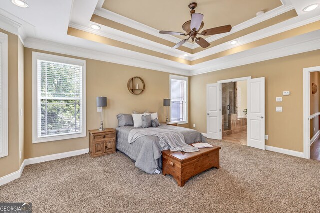 bedroom with baseboards, ornamental molding, carpet, and a tray ceiling