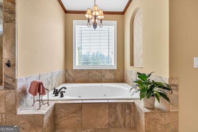 bathroom with a tub with jets, crown molding, and an inviting chandelier