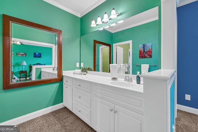 bathroom with crown molding, baseboards, and vanity