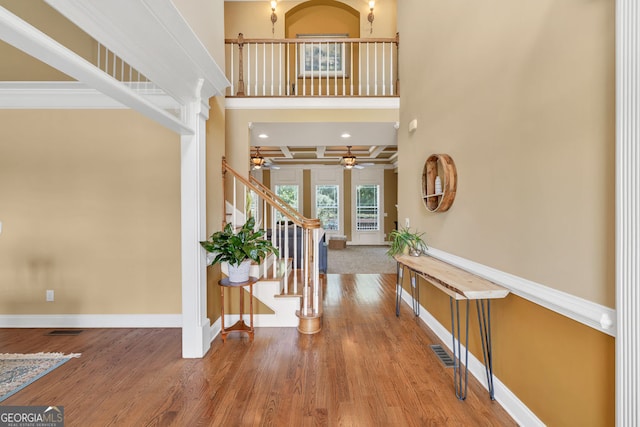 foyer entrance featuring a ceiling fan, baseboards, visible vents, and stairway