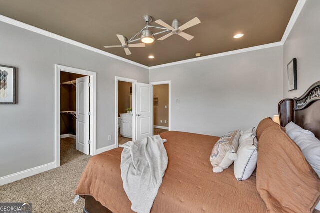 bedroom featuring carpet floors, ornamental molding, baseboards, recessed lighting, and a spacious closet