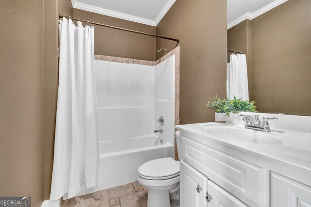 bathroom featuring stone tile floors, toilet, ornamental molding, and vanity