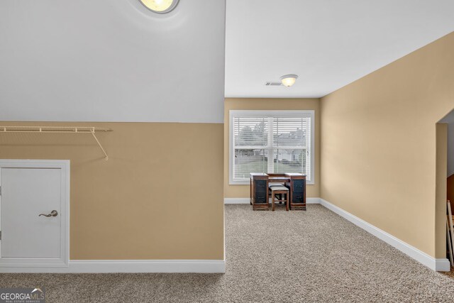 laundry area featuring carpet floors and baseboards