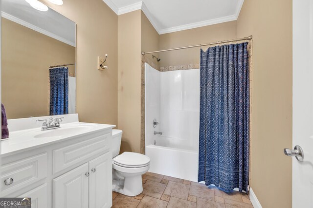 full bathroom featuring crown molding, vanity, toilet, shower / bath combo with shower curtain, and stone finish floor