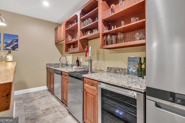 kitchen with appliances with stainless steel finishes, open shelves, a sink, light stone counters, and wine cooler