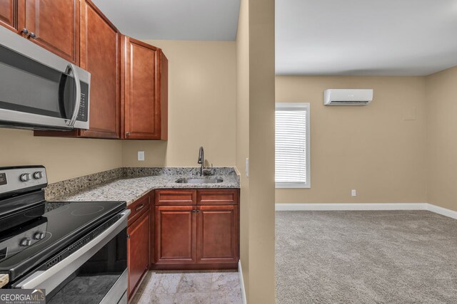 kitchen with appliances with stainless steel finishes, a wall mounted AC, a sink, baseboards, and light stone counters