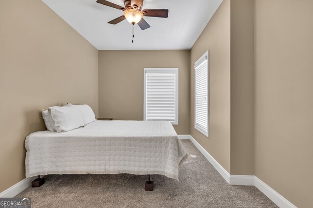 carpeted bedroom featuring a ceiling fan and baseboards