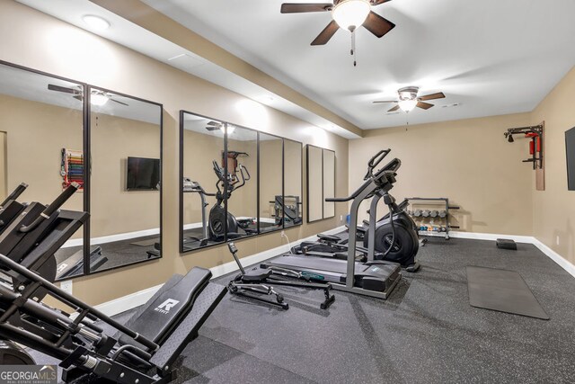 gym with ceiling fan and baseboards