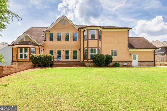 back of property featuring a lawn