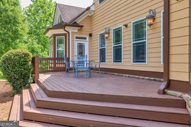 deck with outdoor dining area