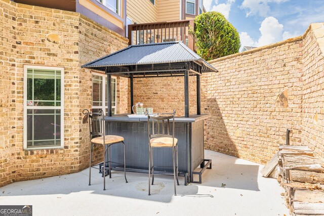 view of patio / terrace with outdoor dry bar and a gazebo