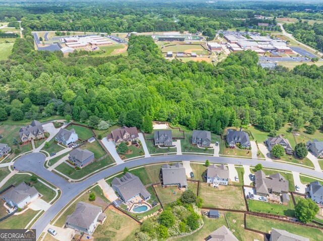 birds eye view of property featuring a view of trees and a residential view