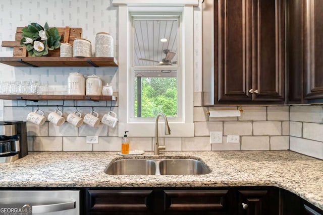 7730 Tiberon Pkwy, Cumming, GA 30028 - kitchen featuring decorative backsplash, dark brown cabinetry, dishwasher, a sink, and light stone counters