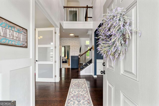 7730 Tiberon Pkwy, Cumming, GA 30028 - entryway featuring visible vents, wood finished floors, stairway, and a towering ceiling