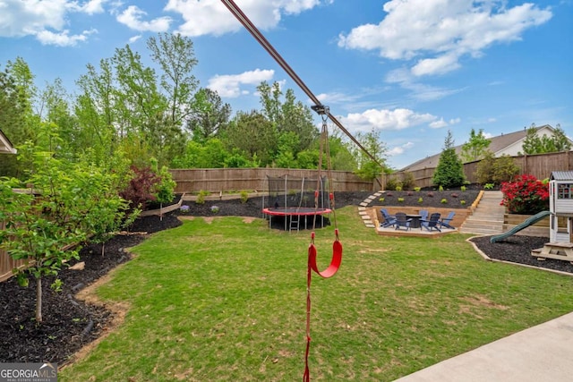 7730 Tiberon Pkwy, Cumming, GA 30028 - view of yard featuring a fenced backyard, a trampoline, and a patio area